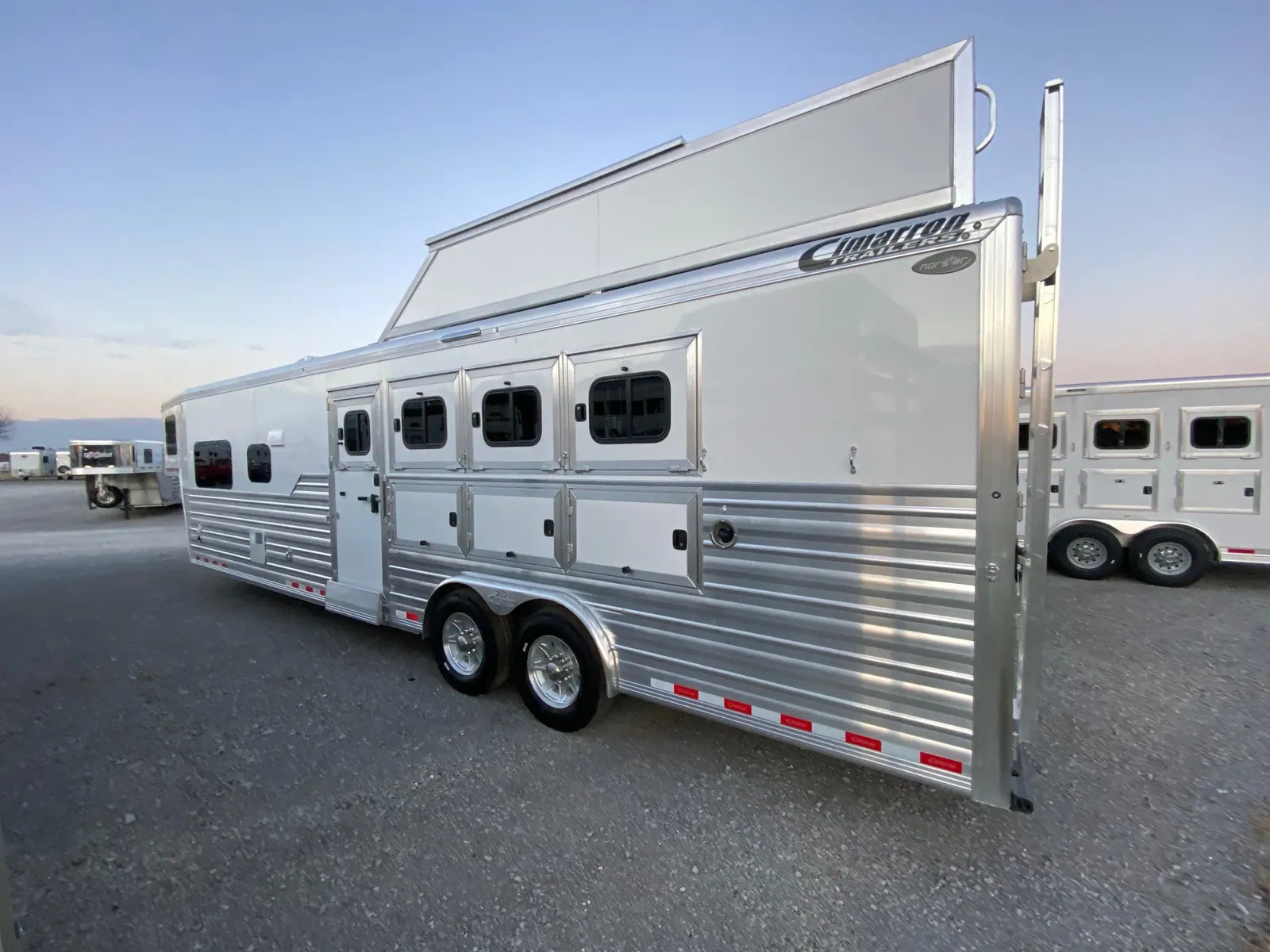 2024 Cimarron Trailers 8412 Outback Customs 4 Horse LQ at sunset